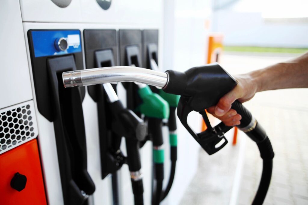 A person pumping gas into their car.